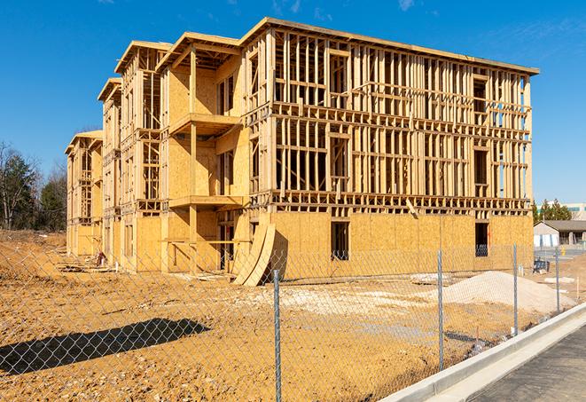 a close-up of temporary chain link fences enclosing a job site, signaling progress in the project's development in Athens AL